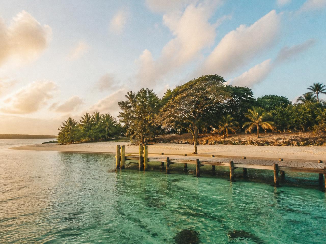 Low tropical islands and shallow turquoise water under a wide sky in far northern Australia