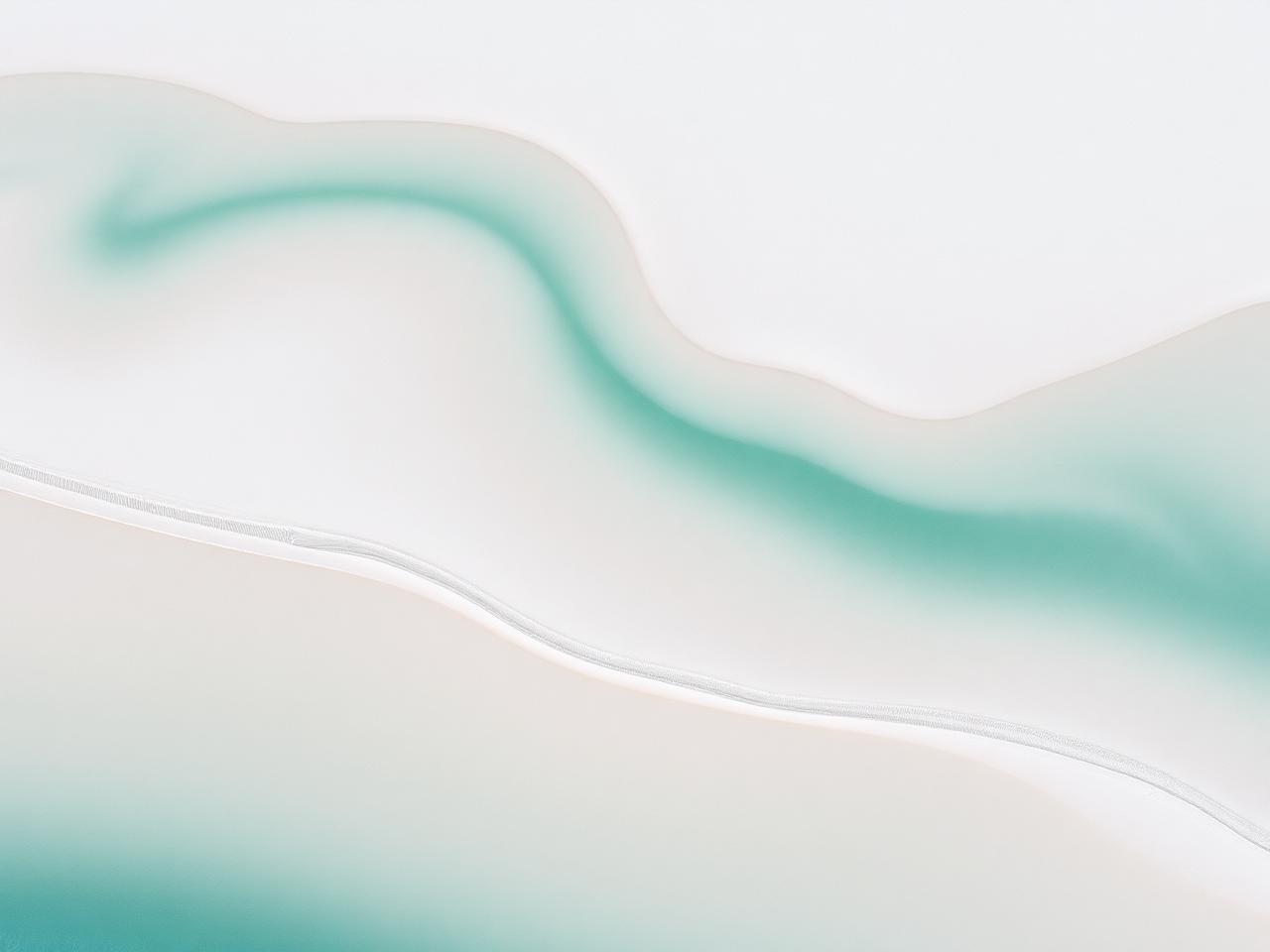 Swirling white sand and shallow tidal channels seen from above at low tide
